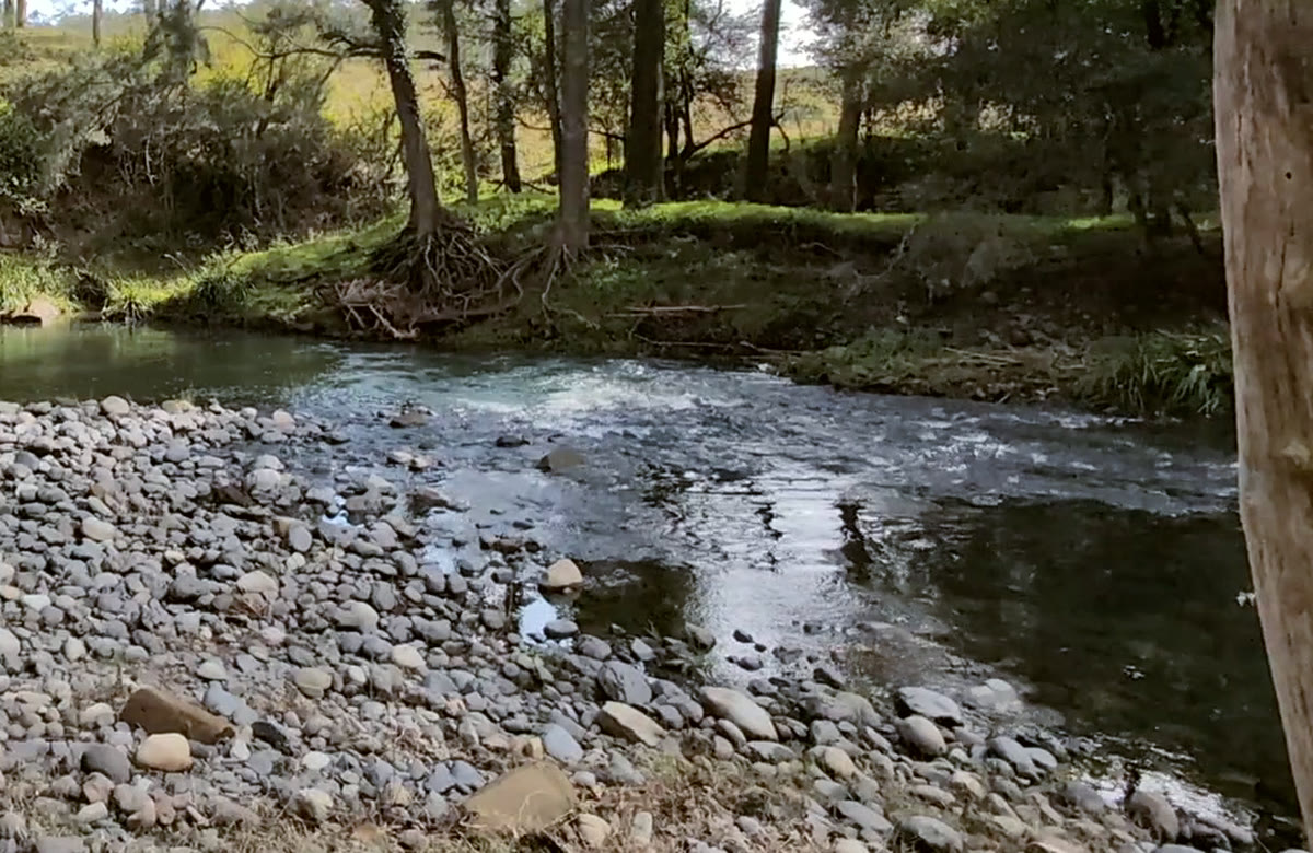 The Allyn running shallow over river stones at the crossing